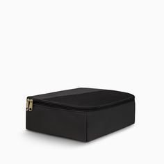 a black box with gold handles on the top and bottom, in front of a white background