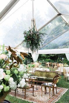 the inside of a tent with tables and chairs