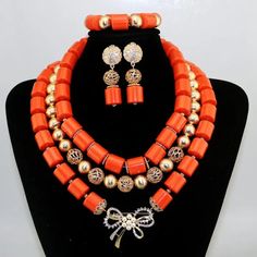 African Wedding Jewelry Catalog | LaceDesign Workshop Traditional Beaded Jewelry For Formal Occasions, Traditional Orange Jewelry With Spacer Beads, Traditional Wedding Beaded Necklaces With Spacer Beads, Red Spacer Beads Jewelry For Wedding, Traditional Large Beads Jewelry For Party, Traditional Colorful Beaded Wedding Jewelry, Elegant Orange Beads For Wedding, Traditional Wedding Jewelry With Colorful Beads, Elegant Orange Beaded Necklace For Wedding