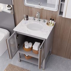 a white sink sitting under a bathroom mirror