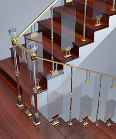 a set of stairs with glass balconies and wooden handrails