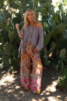 Groovy vibes only while wearing the Groovy Gardens Wide Leg Pant! Get ready for plenty of compliments while wearing these because they feature: Lightweight and flowy woven fabric with an eye - catching floral print throughout Loose and flowy wide leg silhouette High - rise smocked elastic waistline for a comfy fit Convenient side pockets Make a comfy statement in these by pairing with: Sophie Crochet Lace Bralette, Scoop Neck Bralette Tee, Kylie Studded Sandal *Due to lighting and differences in Bohemian Fall Outfits, Flowy Outfit, Harem Pants Outfit, Job Clothes, Groovy Vibes, Bohemian Pants, Gender Neutral Clothes, Boho Clothes, Bohemian Skirt