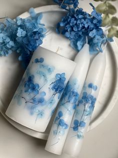 blue flowers and white plates on a table