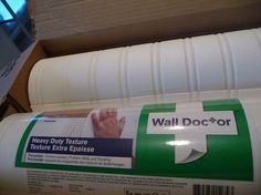 a close up of a wall docor adhesive tape on the side of a cardboard box