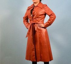 Orange Brown Leather Duster Jacket Vintage Fall Outerwear, Vintage Long Leather Jacket For Fall, Retro Belted Fall Outerwear, Vintage Double-breasted Leather Jacket For Fall, Retro Belted Outerwear For Fall, Retro Outerwear With Pockets For Office, Retro Formal Fall Outerwear, Vintage Fitted Belted Outerwear, Fitted Vintage Belted Outerwear