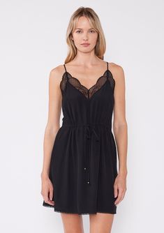 A new take on the classic little black dress, designed to blend timeless elegance with modern versatility. Featuring an adjustable cinched waist for the perfect fit, a delicate lace trim v-neckline and lace racerback. Lace trim Relaxed fit Adjustable cinched waist Sleeveless Mini length V-neckline Racerback detail Adjustable spaghetti straps Embrace the versatility and elegance of this boho chic mini dress, perfect for any occasion, from casual outings to sophisticated events. Model is 5'9, wear V-neck Contrast Lace Slip Dress For Night Out, Black V-neck Slip Dress With Lace Trim, Chic V-neck Dress With Delicate Lace, Black Sleeveless Lace Dress With Delicate Details, Chic Black Slip Dress With Contrast Lace, V-neck Slip Dress With Lace Trim For Date Night, V-neck Lace Trim Slip Dress For Date Night, V-neck Mini Dress With Lace Back, Black Sleeveless Slip Dress With Lace Bodice