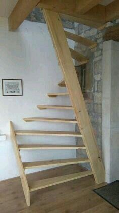 a wooden stair case in the corner of a room