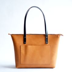 Leather tote bags are a classic accessory that stand the test of time. Our totes are versatile, practical, and classic, making them a must-have addition to any wardrobe. She's a versatile accessory that can be used for a range of purposes, from carrying your laptop to the office to carrying groceries...plus so much more! This bag is built to last!Honey LeatherBlack Leather StrapsBrass Hardware Top 10 Reasons Classic Leather Totes are Must-Haves ... • Fast & FREE Shipping on orders over $150• Mad Timeless Tote Bag With Handles, Classic Rectangular Bucket Bag For Daily Use, Classic Rectangular Bucket Bag For Everyday Use, Classic Top Handle Bucket Bag For Everyday Use, Everyday Rectangular Bucket Bag In Timeless Style, Classic Satchel Bucket Bag For Everyday, Classic Satchel With Handles For Everyday Use, Classic On-the-go Satchel Tote, Modern Cognac Bag With Leather Handles