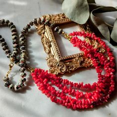 Necklace made of Dalmatian Jasper and four strands of bamboo coral on red cord -SINGLE PIECE- Hand-knotted necklace with a striking center section made of coral splinters and rondelles made of Dalmatian Jasper. The necklace has a total length of approx. 61 cm. All metals are nickel and lead free and also suitable for allergy sufferers. Shipping to the USA is free for purchases of at least $35! Your order will be safely packaged and delivered to you by DHL! Please note that there may be delays in delivery, especially before holidays. Gemstones and coral are natural products, colors may vary slightly from those shown! Traditional Multi-strand Red Coral Necklaces, Multi-strand Red Coral Beaded Necklaces, Multi-strand Red Coral Jewelry Gift, Artisan Multi-strand Red Necklaces, Handmade Multi-strand Red Coral Necklace, Multi-strand Red Coral Beaded Necklace As Gift, Multi-strand Red Coral Necklace With Polished Beads, Red Multi-strand Gemstone Beads Necklace, Multi-strand Red Coral Beaded Necklace For Gift