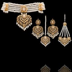 Elevate your ensemble with this resplendent set and create a grandeur and graceful look! A lustrous pearl ensemble that is a testament to enduring beauty creates a cascade of sophistication with CZ stones. The set includes a choker, a maang teekah, a jhoomar/passa and a pair of earrings. Gold-plated on high-quality brass as base metal. Made by order. Kindly allow 5-7 weeks for the delivery of this item. For custom or urgent requests, please contact support@alacouture.com. *Please Note: We use fa Elegant Kundan Bridal Sets For Eid, Elegant Kundan Sets For Ceremonial Occasions, Elegant Pearl Sets With Stone Work, Bollywood Style Pearl Sets With Stone Work, Pearl Chandbali Sets With Stone Work, Elegant Bridal Sets For Eid, Elegant Bridal Necklace For Eid Ceremony, Elegant Ceremonial Bridal Necklace For Eid, Elegant Wedding Choker For Diwali