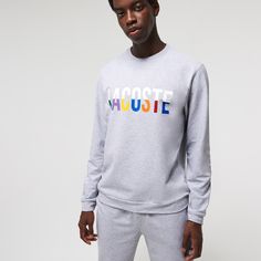 Adorned with oversized multicolor brand lettering, this solid lounge sweatshirt is perfect for kicking back. Crafted in soft cotton blend fleece, it has a classic straight cut and a ribbed crew neck. Get the total look when you pair it with the coordinating pants. Winter Athleisure Sweatshirt With Logo, Casual Winter Sweatshirt With Logo Detail, Casual Winter Sweatshirt With Logo, Sporty Cotton Sweater With Text Print, Casual Cotton Fleece Sweats For Loungewear, Winter Loungewear Sweatshirt With Logo, Spring Letter Print Sweatshirt Loungewear, Spring Letter Print Sweatshirt For Loungewear, Cotton Sweats With Logo Print For Loungewear