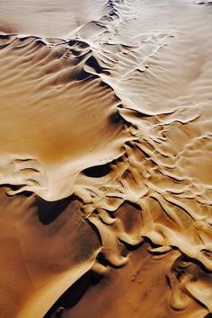 an aerial view of sand dunes in the desert