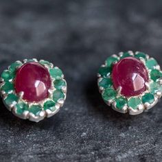 Victorian Emerald Earrings set with a Natural Emeralds in a diamond cut at 3mm each. With Natural Ruby set in the center in a stunning smooth quality, at 10x8mm each (6 Cts pair) from Burma.Solid 925 Sterling Silver ☞ made to last.Click here for ☞ Matching RingClick here for ☞ Matching PendantDetails:• Natural Ruby (Burma), Natural Emerald (Colombia)• Ruby: 10x8mm each, 6 Cts a pair, cabochon cut• Emeralds: 3mm each, 3 Ct a pair, diamond cut• Lever Back Closure - "English Lock"• Dimensions: Leng Ruby Set, Ruby Earrings, Emerald Earrings, July Birthstone, 3 Carat, Natural Ruby, Natural Emerald, Diamond Cut, Designer Earrings