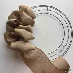 a wreath with burlocked fabric on it and a metal ring around it