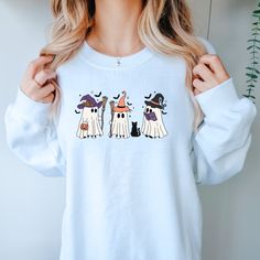 Get ready for Halloween with our Witchy Ghosts Sweatshirt! Featuring adorable ghosts dressed as witches, this cozy sweater will keep you warm while spreading spooky vibes. Perfect for those who love cute and playful Halloween fashion. Ghost Dresses, Get Ready For Halloween, Ready For Halloween, Spooky Vibes, Halloween Fashion, Cozy Sweater, Love Cute, Cozy Sweaters, White Sweaters