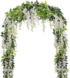 an arch with white flowers and green leaves