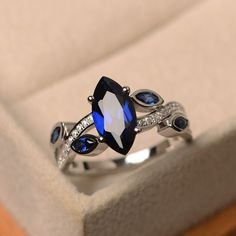 This ring features a 6*12 mm marquise cut lab sapphire. Customization is available. It is made by hand, and it will take about 7 days to finish the ring after your payment is completed. Main stone: 6*12mm marquise cut lab sapphire Main stone weight:2.30ct Metal type: sterling silver finished with rhodium/14k gold Accent stone: none Customization is available, I also can make it with 14k solid gold (white or yellow or rose) and diamond accent stone, just feel free to contact me. Any question, jus Sapphire Anniversary Band, Marquise Cut Rings, Sapphire Solitaire Ring, Blue Gemstone Rings, Sapphire Solitaire, Blue Sapphire Ring, Sapphire Engagement Ring Blue, Sterling Silver Engagement Rings, Band Engagement Ring