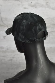 Baseball Cap with a unique, edgy twist. Crafted from high-quality black cotton, this cap is designed to embrace the rugged aesthetic of a post-apocalyptic world, featuring prominent visible stitching and deliberate distressing for that perfectly worn-in look. The focal point of this cap is the eye-catching patch - a piercing eye peering through a shattered heart, reminiscent of classic, old-school tattoos. This emblem adds an element of mystery and intrigue to the cap, making it a true conversation starter. Whether you're a fan of dystopian fashion or simply looking to stand out from the crowd, this cap is the perfect choice. With an adjustable strap for a custom fit, it's comfortable and versatile, making it suitable for both casual and adventurous outings. It's a one size product. Please Punk Style Cap Hat, Punk Cap Hat One Size Fits Most, Punk Style Cap One Size Fits Most, Distressed Baseball Cap For Streetwear, Adjustable Punk Style Baseball Cap, Punk Style Adjustable Baseball Cap, Adjustable Punk Baseball Cap For Streetwear, Black Snapback Baseball Cap Punk Style, Black Punk Style Snapback Baseball Cap