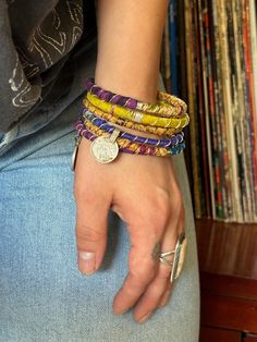 Stack up on these colorful & bold boho bangles!  I wrap each bracelet by hand with unique upcycled sari silk and finish with a wire wrap to secure.  Add vintage kuchi coin charms to a few or all to complete the look, These bracelets are a super simple and lightweight for easy, comfortable wear. Select one or mix and match to create your own personalized set! ★ Handmade ★ Upcycled Sari Silk ★ Non-Tarnish Wire ★ Vintage Kuchi Coin Charm ★ 65mm inner diameter ✉ Message for Custom Requests ✈ Free Sh Handmade Bohemian Braided Bracelet For Festivals, Bohemian Hand-wrapped Bracelets For Festivals, Bohemian Braided Bracelets For Festivals, Adjustable Multicolor Spiritual Cuff Bracelet, Multicolor Bohemian Bracelets For Festivals, Bohemian Multicolor Bracelets For Festivals, Bohemian Handmade Friendship Bracelets For Festivals, Multicolor Bohemian Bracelet For Festivals, Spiritual Hand Wrapped Wrap Bracelet For Festival