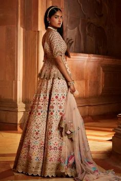 Blush pink raw silk lehenga with multicolor resham embroidery with attached can-can, zari, dabka, beadwork and crystals. Comes with matching embroidered padded peplum top and tulle dupatta.
Component: 3
Pattern: Embroidered
Type Of Work: Floral Resham, Zari, Dabka, Beads and Sequins
Neckline: Plunged V-Neck
Sleeve Type: Half
Fabric: Raw Silk, Tulle
Color: Pink
Other Details: 
Sheer peplum panels
Back tassel tie-up
Scalloped hem details
Occasion: Bride, Wedding - Aza Fashions Designer Art Silk Sharara With Tilla Details, Unstitched Tilla Lehenga For Wedding, Unstitched Wedding Lehenga With Tilla Embroidery, Wedding Lehenga Unstitched With Tilla, Designer Raw Silk Choli With Tilla, Designer Raw Silk Choli With Tilla Details, Designer Tilla Lehenga For Eid, Designer Semi-stitched Tilla Choli, Eid Designer Lehenga With Tilla Details