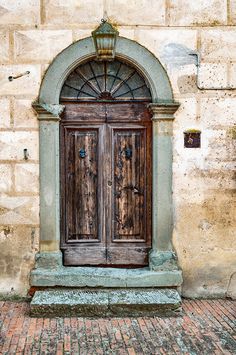 an old wooden door on the side of a building