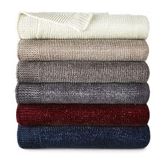 folded towels and blankets in various colors