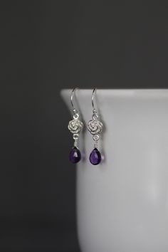 "Sweet faceted Purple Amethyst teardrops are carefully wire wrapped with silver wire onto Bali Silver rose flower links. These dangle from balled silver earwires. Wear these lightweight petite everyday to work or with your favorite jeans. Perfect for girls and women of any age. Bali Silver rose link: 7x12mm Amethyst teardrops: 5x7mm Total length of earrings: 1 1/4\" All silver is sterling. As the owner, maker, designer, and curator of this shop, I take great pride in providing you with jewelry t Elegant Adjustable Wire Wrapped Teardrop Earrings, Purple Sterling Silver Teardrop Dangle Earrings, Elegant Wire Wrapped Briolette Teardrop Earrings, Amethyst Teardrop Crystal Earrings, Sterling Silver Teardrop Pierced Flower Earrings, Silver Wire-wrapped Teardrop Earrings, Silver Amethyst Wire Wrapped Earrings, Elegant Wire Wrapped Long Drop Teardrop Earrings, Nickel-free Sterling Silver Teardrop Flower Earrings