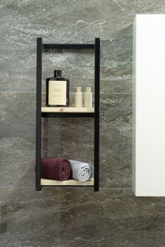 a shelf with towels, soaps and bottles on it