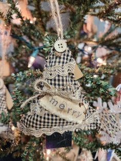 an ornament hanging from the top of a christmas tree with burlocks