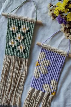 two handmade wall hangings with flowers on them