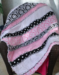 a pink and black blanket on top of a chair