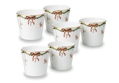 four christmas themed cups with bows and ribbons on the rims, all decorated in gold