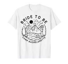 a white t - shirt with the words bride to be on it and mountains in the background