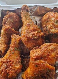 chicken wings with parsley on top in a takeout container