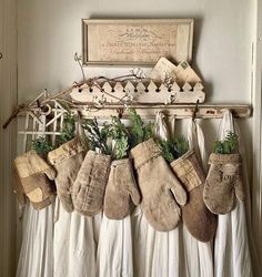 stockings hanging on a rack with plants in them and an old sign above the stockings