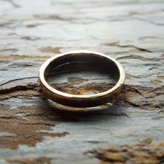 "To create this humble, minimalist band, I start with thick, solid 14k gold wire that I join to form a perfect circle, then hammer for a subtle texture. This band is hand polished for high shine, but can also be made with a matte finish upon request (select color and finish from drop down menu at checkout). Each band measures just over 3mm wide and 1.5mm thick, and is joined with 14k cadmium free, color match, plumb-gold solder to ensure a seamless join and the highest possible gold content. Rin Gold Band Wedding Ring, Hammered Gold Ring, Gold Ring Wedding, Perfect Circle, Ring Wedding Band, Hammered Gold, A Perfect Circle, Subtle Textures, Gold Wire