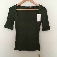 Reformation Leanne Knit Top In Fern Green Sz M Square Neck Ribbed Tencel Modal Soft Stretchy Brand New With Tags. Made In Usa. Comes In Original Reformation Packaging. Armpit To Armpit: 15 1/4 Length (Shoulder Seam To Hem): 23 Top It Off. The Leanne Is A Fitted Top With A Square Neckline. It Features Short Sleeves And Can Be Worn Day-To-Night If You Ask Us. It's Soft And Stretchy For An Extra Comfortable Feel. The Leanne Knit Top Pairs Well With The - Fitted Bodice - Knit Fabric - Short Sleeve - Fitted Green Ribbed Knit Top, Fitted Green Fine Knit Tops, Fitted Fine Knit Green Tops, Forest Green Color, Fern Green, Square Neck Top, Fitted Top, Fitted Bodice, Half Sleeve