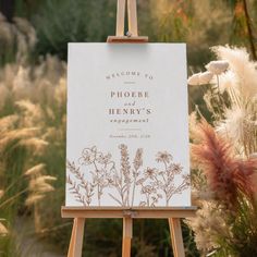 an easel with a sign that says welcome to phoer and henry's engagement