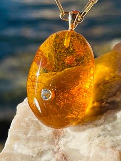 Pendant material and details : * Natural Baltic amber  * Blue topaz * Type of Amber : Transparent  * Color of Amber : Honey , Cognac  *  * Metal :Gold 14K (585*) hallmark & brand logo AMAD  * Size of pendant : 3,2 * 2,1 cm Amber Pendant, Marken Logo, Amber Stone, Baltic Amber, Mother Nature, Online Jewelry, Gold Pendant, Blue Topaz, Cognac