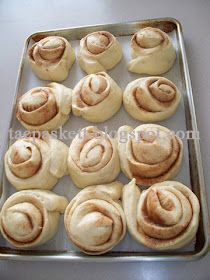 freshly made cinnamon rolls sitting on a baking sheet ready to go into the oven or bake