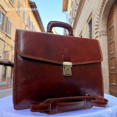 This Italian leather briefcase bag is expertly handcrafted in Florence, Italy, using the finest genuine leather. Designed for men seeking premium quality, luxury, and modern Italian fashion. Elevate your style with this exquisite accessory. . Size: Height: 29 cm (11.42 inches) Width: 41.50 cm (16.34 inches) Depth: 12 cm (4.72 inches) Color: Dark Brown . The story of this bag: Embark on a journey of timeless elegance with our Handmade Leather Briefcase from the heart of Florence, Italy. Meticulou Classic Business Shoulder Bag With Case, Luxury Bags For Business Meetings, Cognac Rectangular Business Cases, Luxury Cognac Briefcase For Business Trips, Luxury Briefcase With Case Included For Business Trips, Leather Business Briefcase With Case Included, Designer Smooth Grain Rectangular Briefcase, Designer Rectangular Briefcase With Smooth Grain, Leather Rectangular Briefcase With Case Included