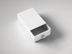 an open white box on a gray surface