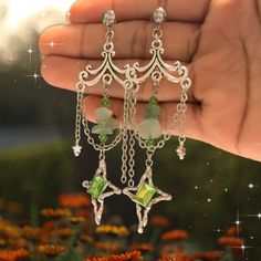 ✨"Elevate your style with our Silver Chandelier Earrings, each pair a unique and magical creation! ✨  These stunning earrings feature intricate silver designs adorned with colorful accents, making every pair one-of-a-kind. The elegant chandeliers catch the light beautifully, adding a touch of whimsy and sophistication to any outfit. Whether you're dressing up for a special occasion or adding a dash of magic to your everyday look, these earrings are sure to turn heads. Embrace the enchanting allu Elegant Silver Chandelier Earrings With Dangling Charms, Silver Chandelier Earrings With Dangling Charms As Gift, Chandelier Dangle Earrings With Dangling Charms For Gift, Silver Fantasy Dangle Jewelry, Silver Dangle Fantasy Earrings, Silver Dangle Crystal Earrings, Mystical Sterling Silver Earrings In Silver, Mystical Silver Sterling Silver Earrings, Silver Fantasy Pierced Earrings