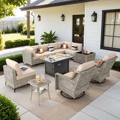 an outdoor living area with furniture and tables