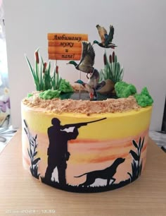 a cake decorated to look like a hunting scene