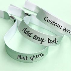 three silver wristbands with words on them that say, custom wristbands add any text