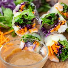 several rolls with lettuce, carrots and sauce