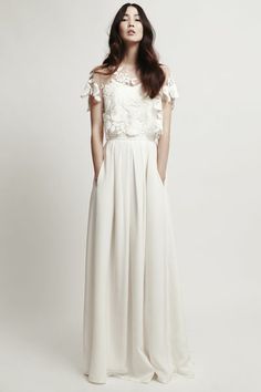 a woman in a long white dress with flowers on her head and the words mystic rose top