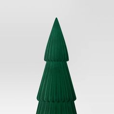 a small green christmas tree sitting on top of a table