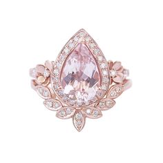 a pink diamond ring with diamonds around it